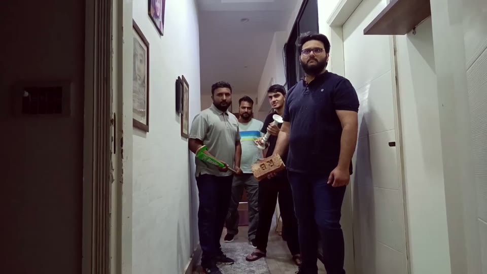 Shot 8 — family in corridor with bat, bricks, hockey stick